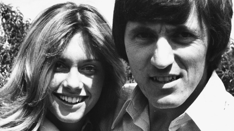 olivia newton-john and bruce welch in black and white photo