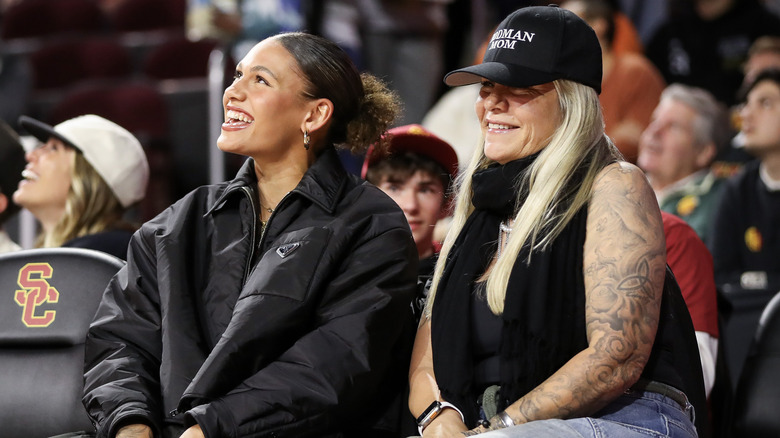 Trinity Rodman and Michelle Moyer courtside