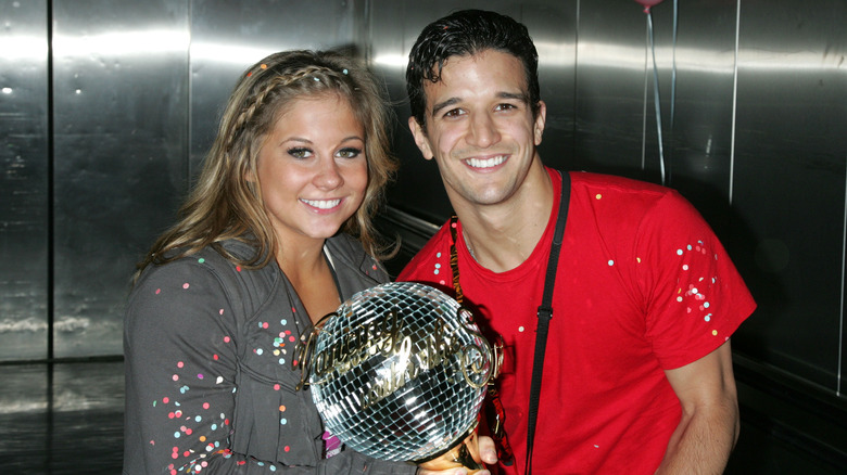 Shawn Johnson and Mark Ballas posing with the Mirrorball Trophy