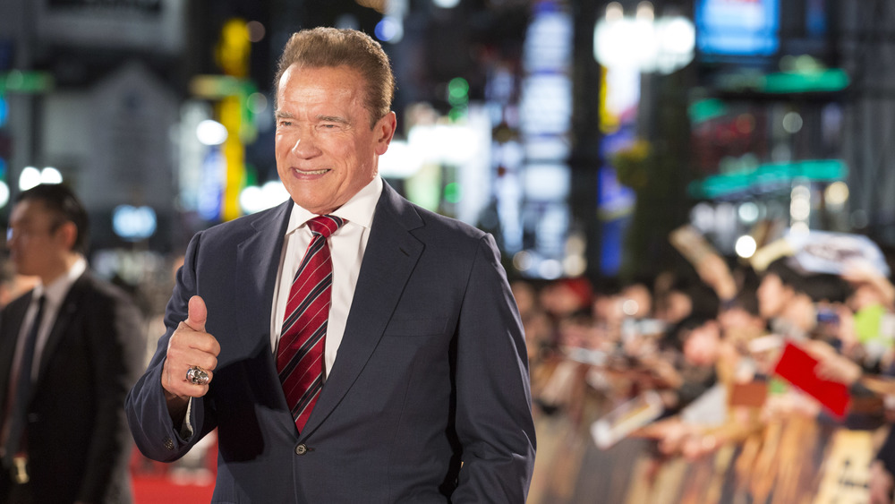 Arnold Schwarzenegger giving thumbs up outside