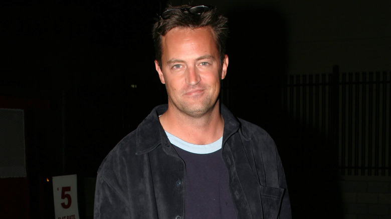 Matthew Perry with sunglasses on his head