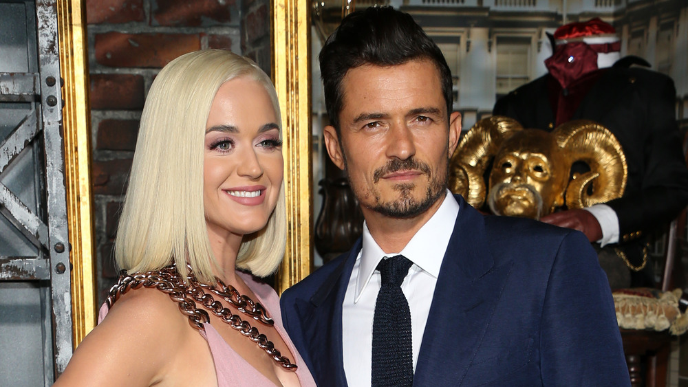 Katy Perry and Orlando Bloom posing together on the red carpet