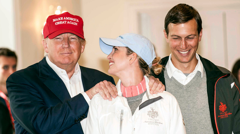 Donald Trump posing with Ivanka Trump and Jared Kushner at a press conference