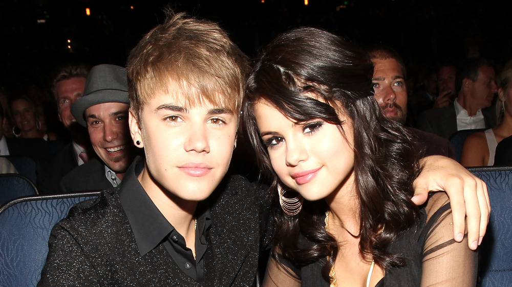 Justin Bieber with his arm around Selena Gomez