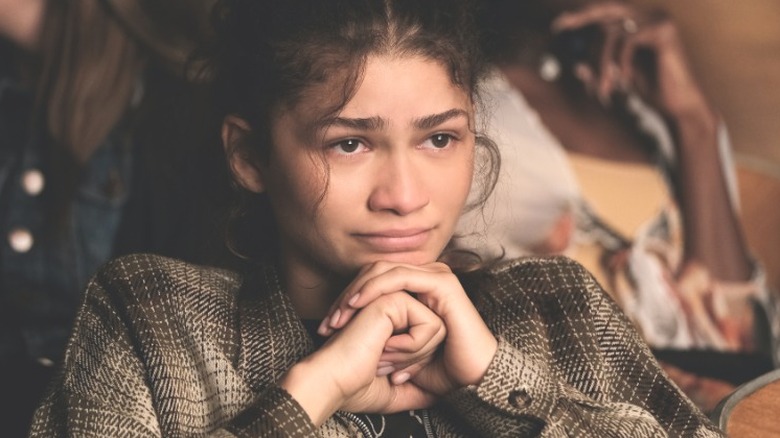 Zendaya with head on hands looking tearful