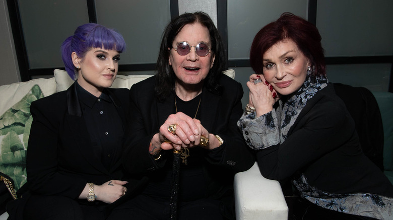 Kelly, Ozzy, and Sharon Osbourne smiling