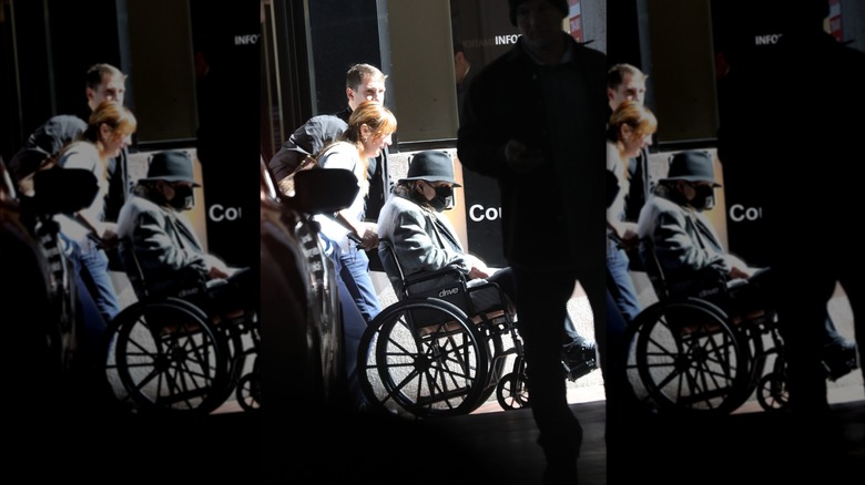 Ozzy Osbourne being pushed in wheelchair