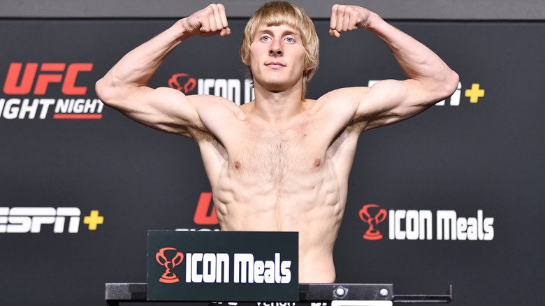 Paddy Pimblett flexing both arms at weigh in