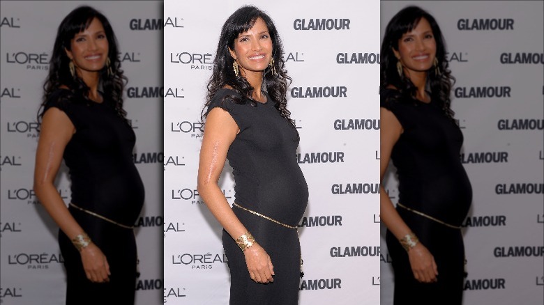 Padma Lakshmi pregnant in a fitted black dress.