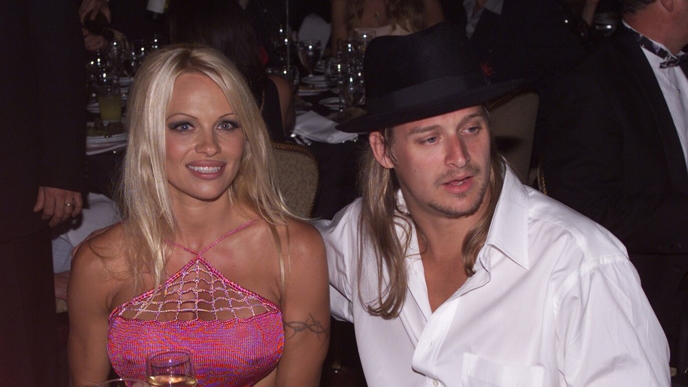 Pamela Anderson and Kid Rock sitting at a Hollywood dinner