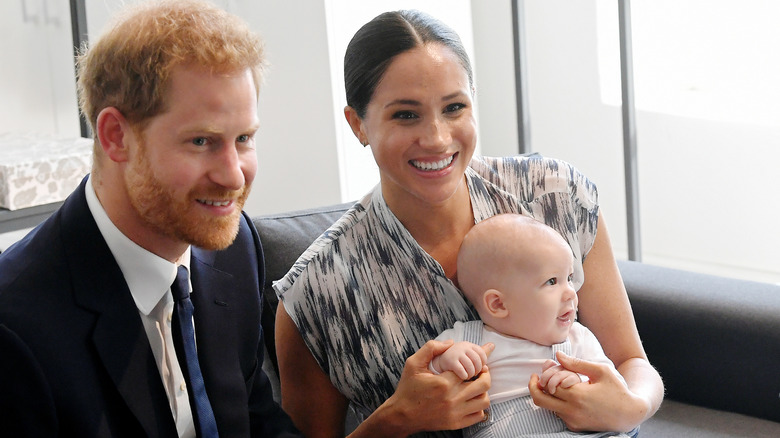 Harry and Meghan smiling with their son Archie