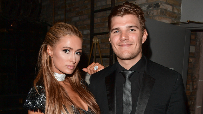 Paris Hilton and Chris Zylka posing