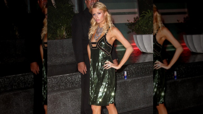 Paris Hilton posing in green sequin dress