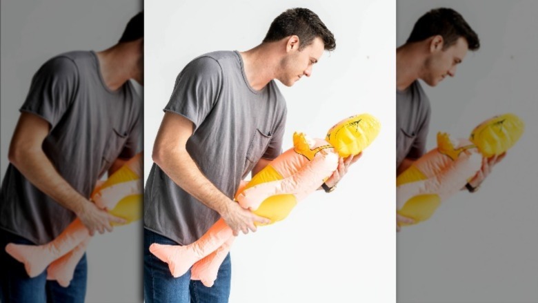 Unmatchables' Caleb holding an inflatable doll 