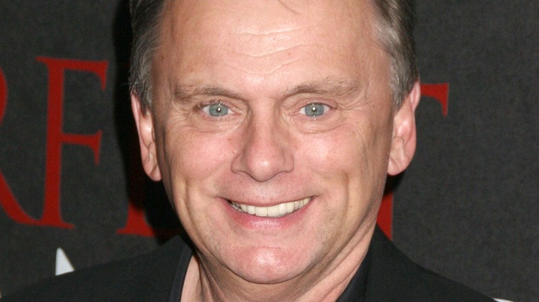 Pat Sajak smiles at an event