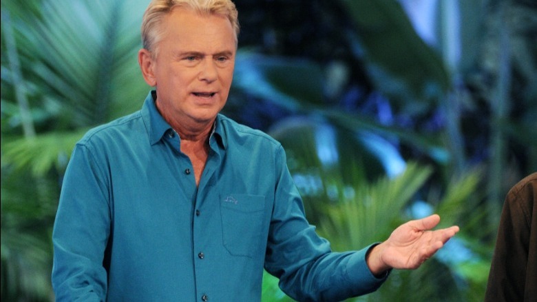 Pat Sajak gestures with his arm