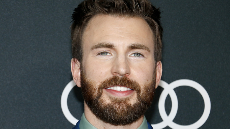 Chris Evans in blue suit and beard 