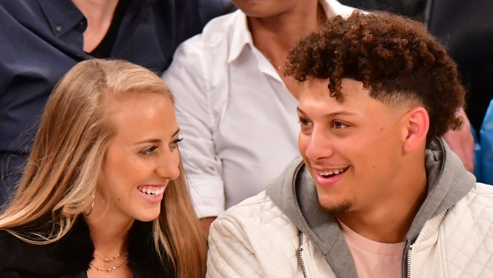 Brittany Matthews and Partick Mahomes sit courtside