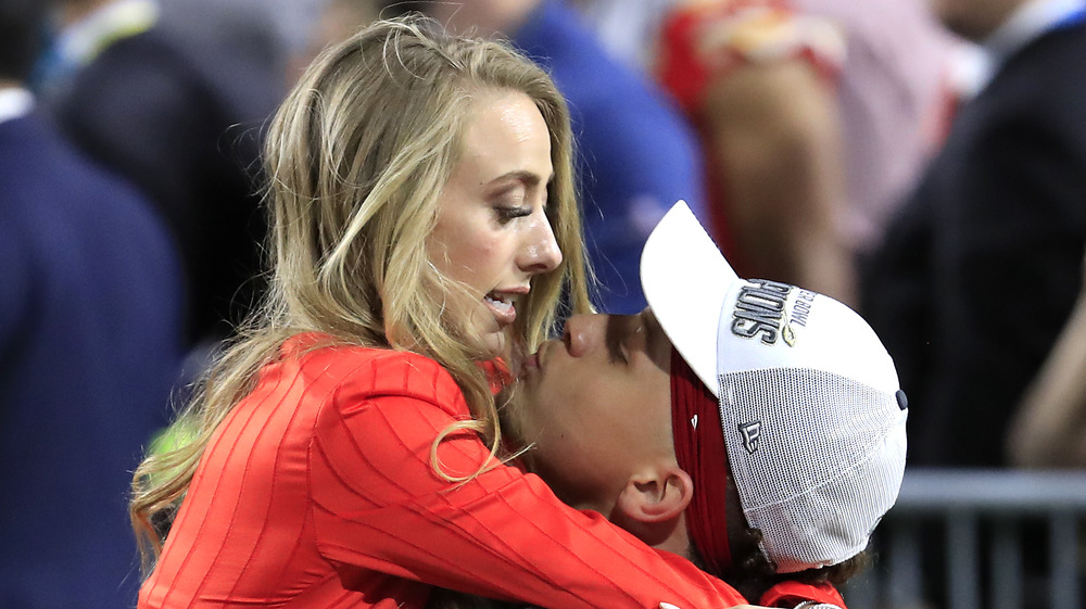 Brittany Matthews & Patrick Mahomes share a kiss at the 2020 Super Bowl