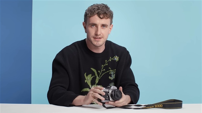 Paul Mescal holding a Nikon camera