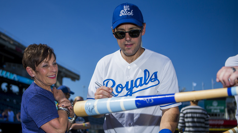 Gloria Rudd watching Paul Rudd sign bat