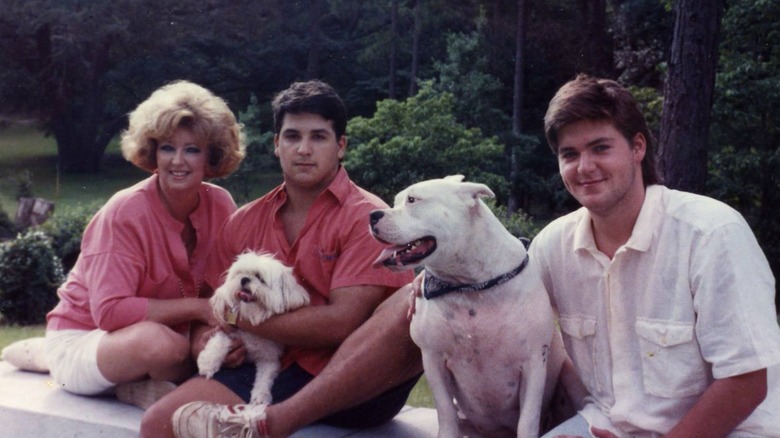 Paula Deen, sons outdoors with dogs