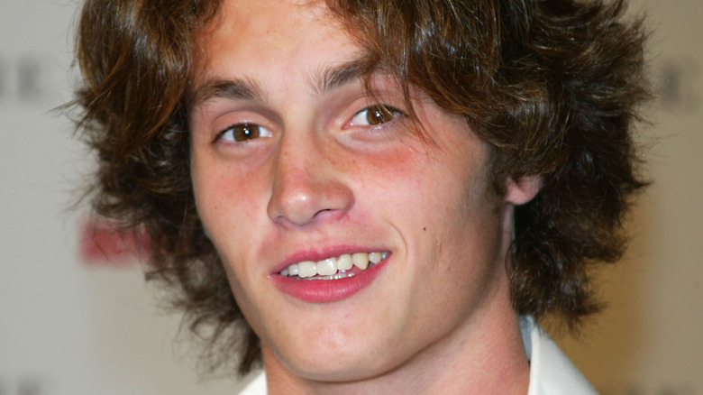 A young Penn Badgley smiling