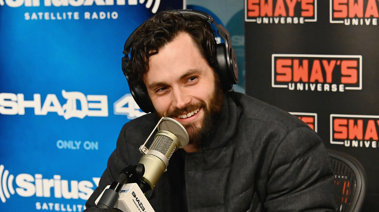 Penn Badgley talking into a microphone