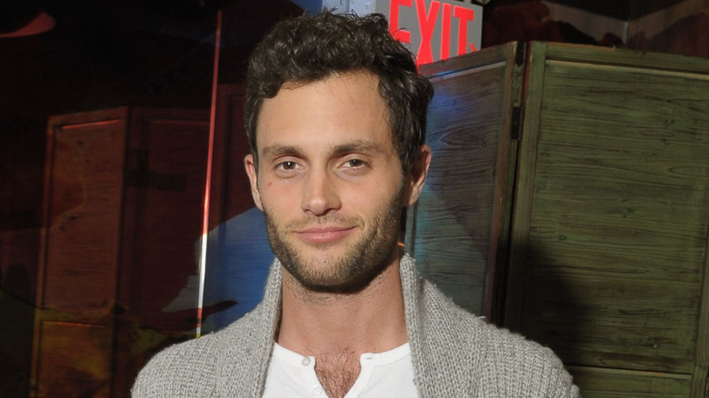 Penn Badgley wearing a cardigan