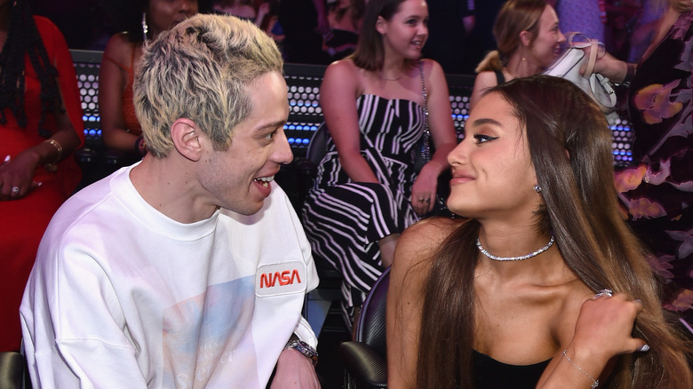 Pete Davidson looking at Ariana Grande