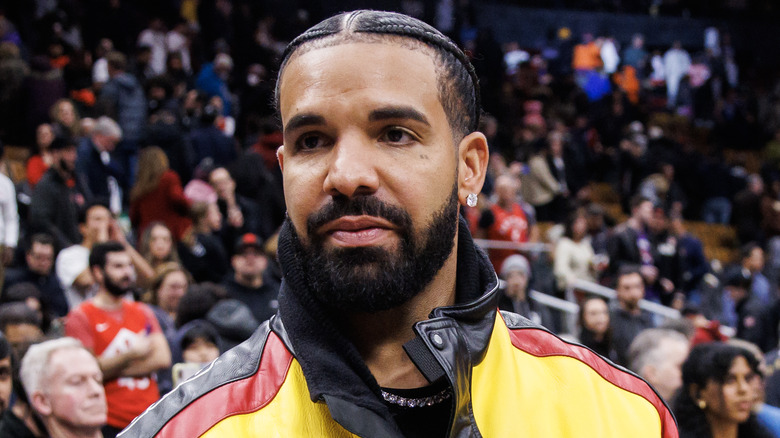 Drake wearing a colorful leather jacket 