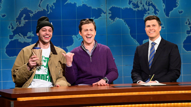 Pete Davidson, Alex Moffat, and Colin Jost laughing on Weekend Update