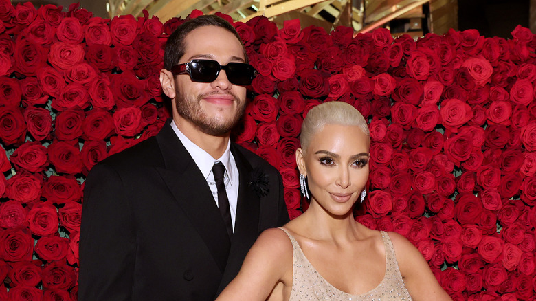 Pete Davidson and Kim Kardashian smiling and posing for photos