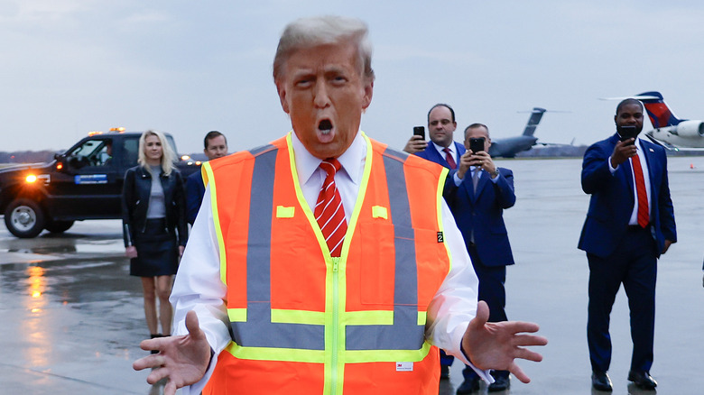 A very tanned Donald Trump speaking to the press while dressed as a garbage man.