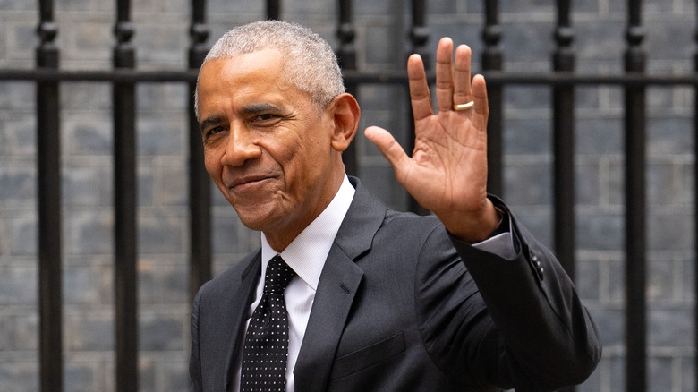 Barack Obama waving dark gray suit