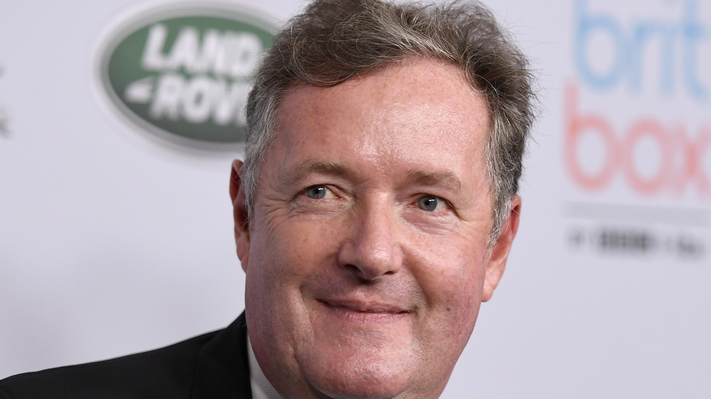 Piers Morgan gives a weary smile on the red carpet