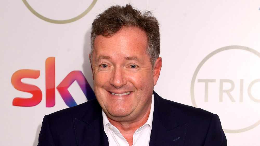 Piers Morgan posing at step and repeat