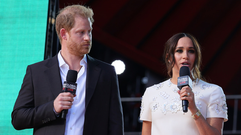 Prince Harry and Meghan Markle speaking on stage