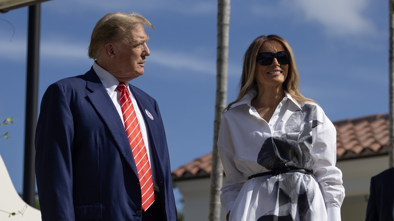 Melania and Donald Trump against blue sky