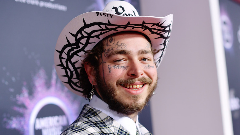 Post Malone smiling with a cowboy hat on