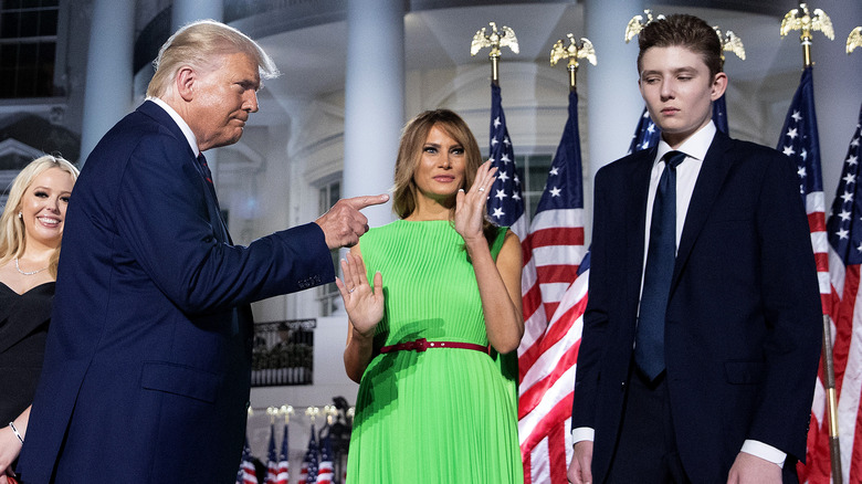 Donald Trump pointing at Barron Trump, with Melania Trump waving