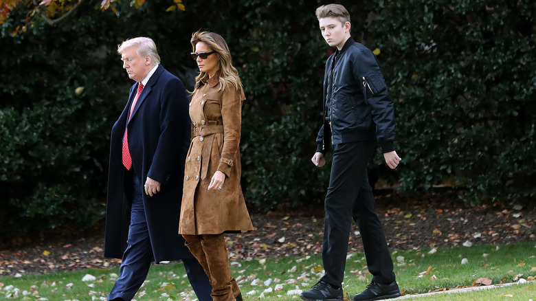 Barron Trump walking behind his parents