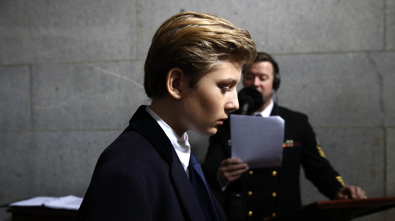 Barron Trump in profile with blue tie 