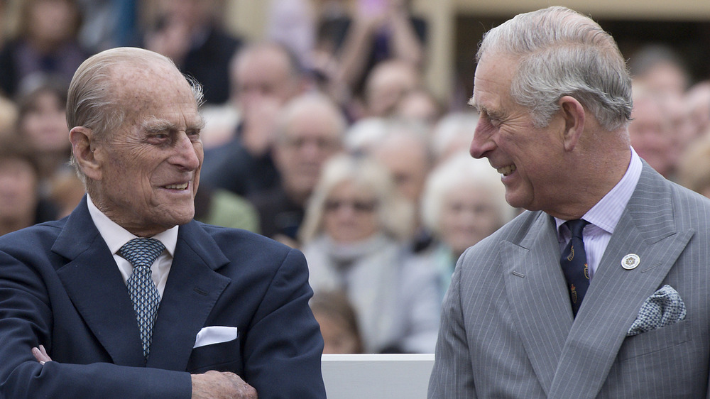 Prince Philip and Prince Charles smiling