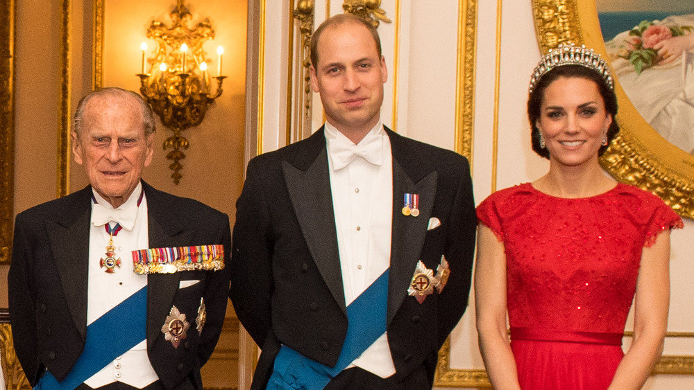 Prince Philip, Prince William, and Kate Middleton posing