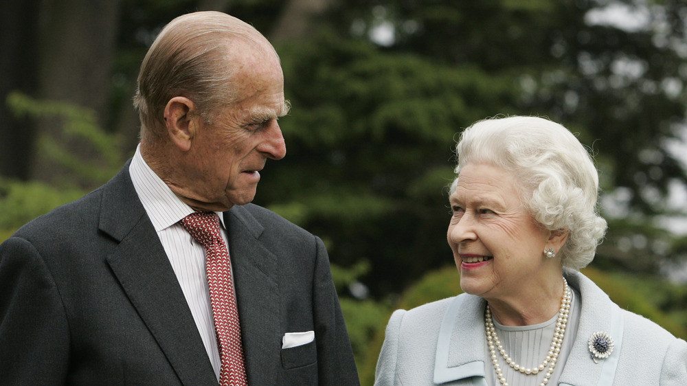 Prince Philip and Queen Elizabeth smiling at each other