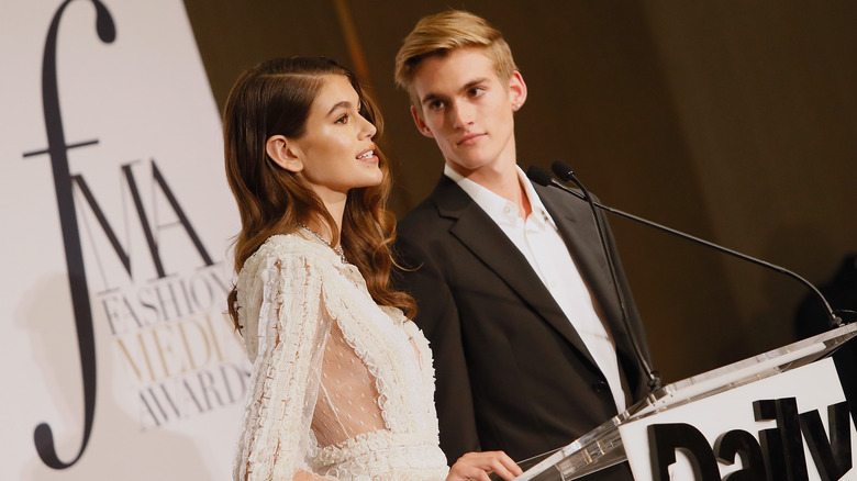 Kaia Gerber and Presley Gerber presenting an award onstage