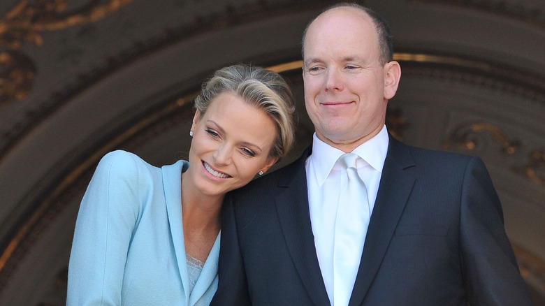 Princess Charlene leaning on Prince Albert