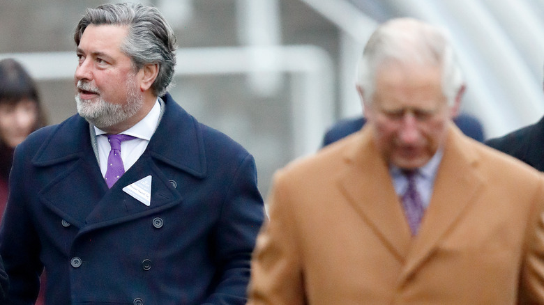 Michael Fawcett walks alongside Prince Charles at an engagement