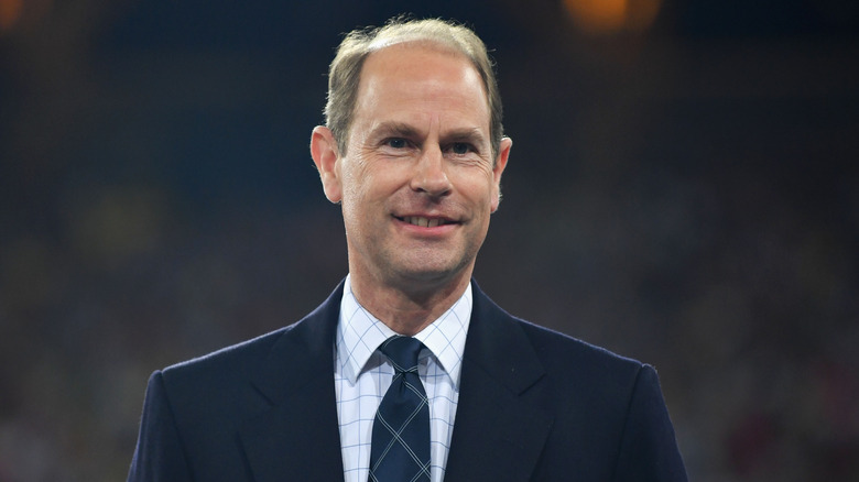 Prince Edward smiling in suit and tie